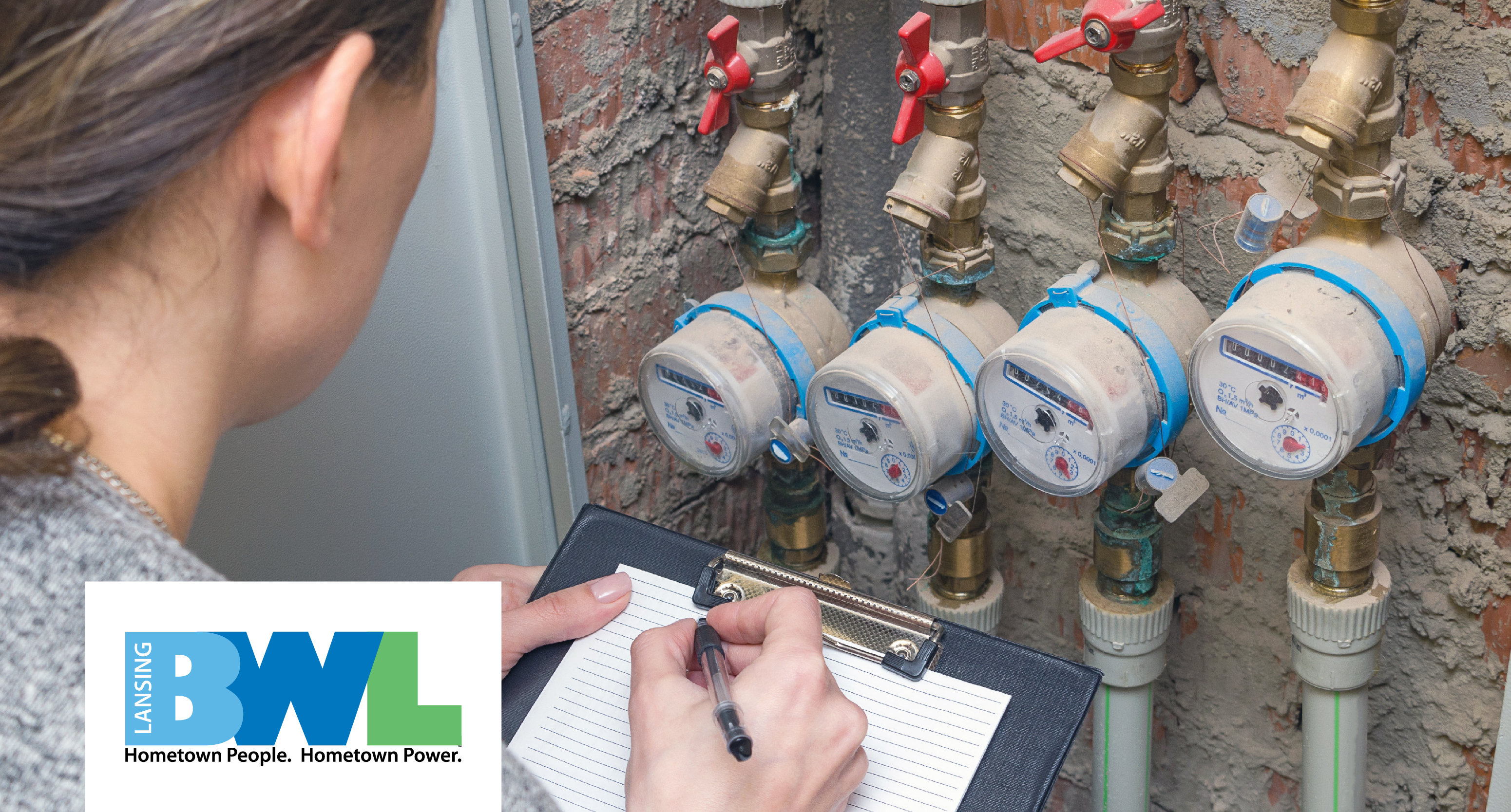 a lady reading electrical meters