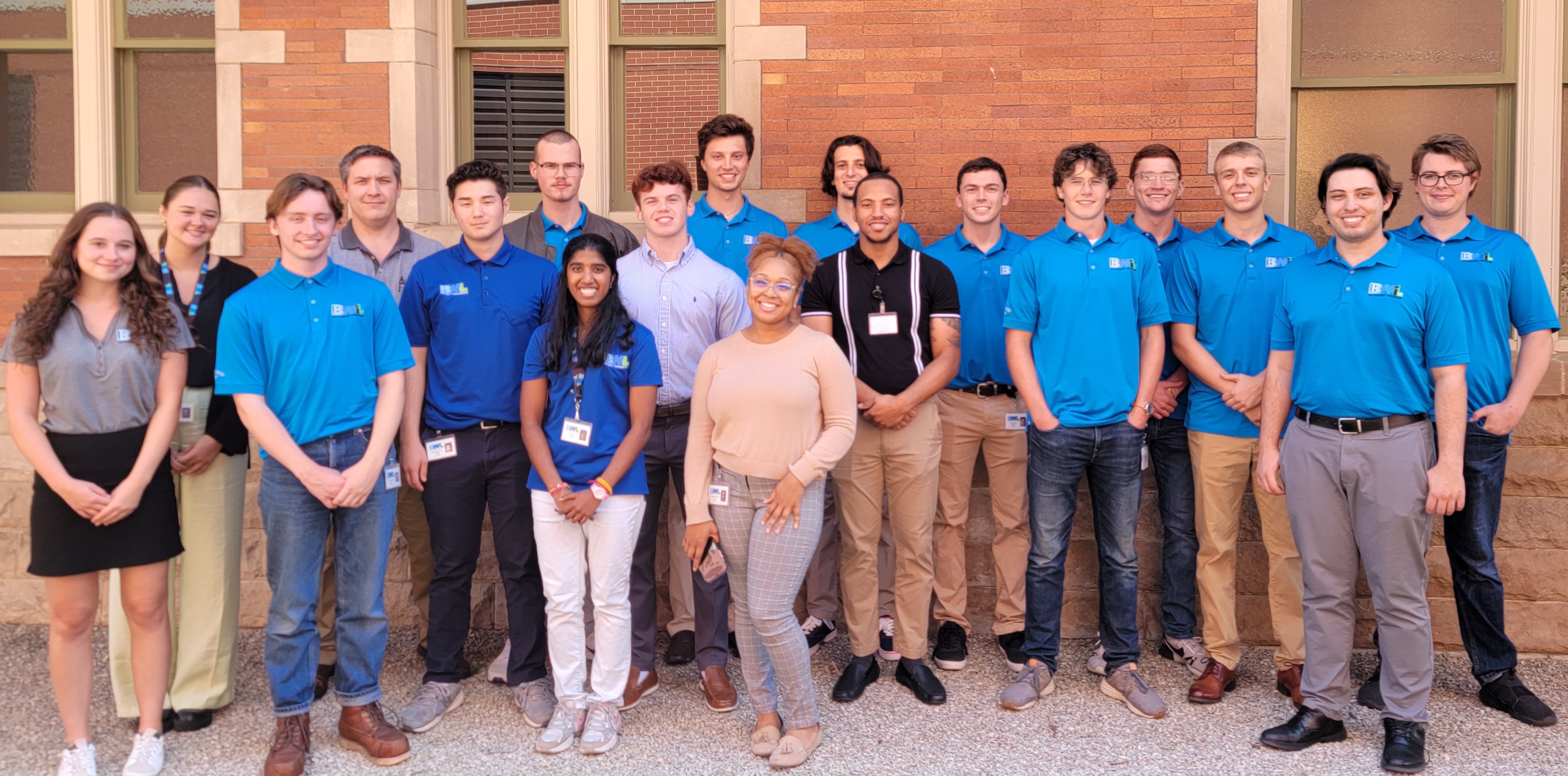 Interns in front of brick wall