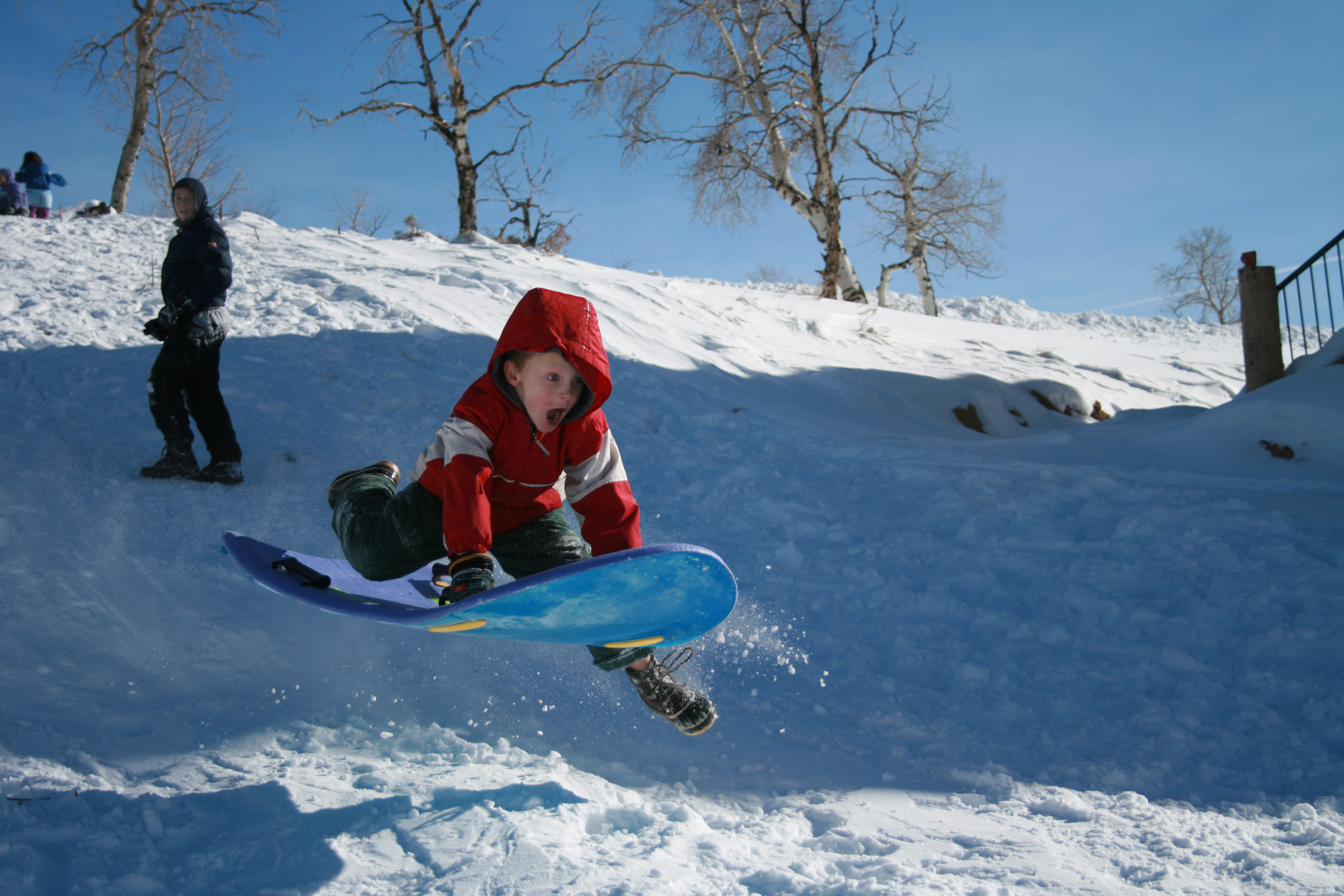 boy sledding in snow