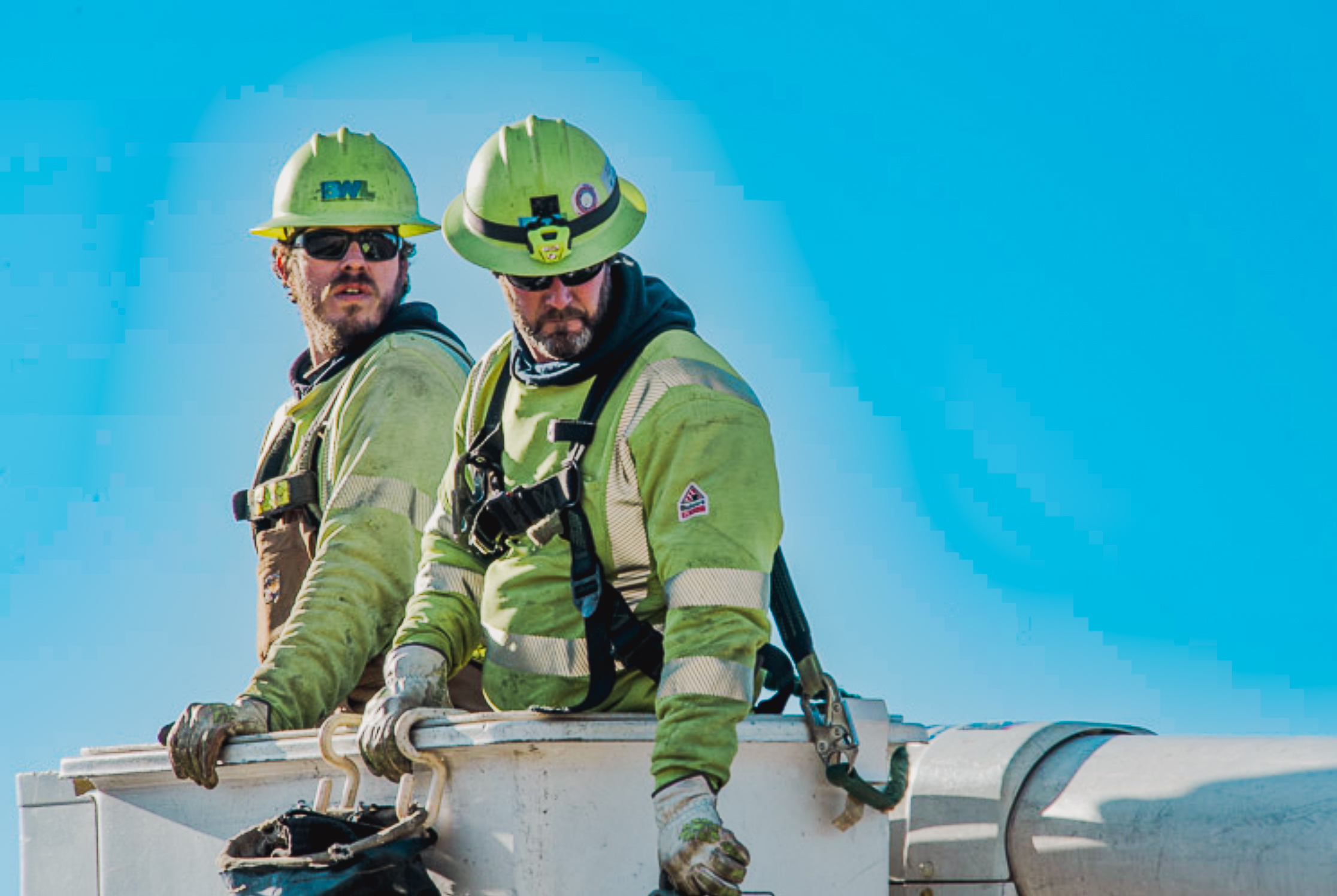 lineworkers in a bucket truck in the air