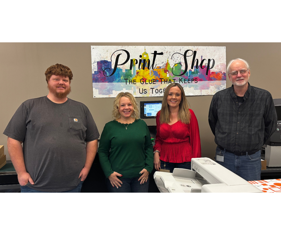 picture of group of 4 people smiling at the camera