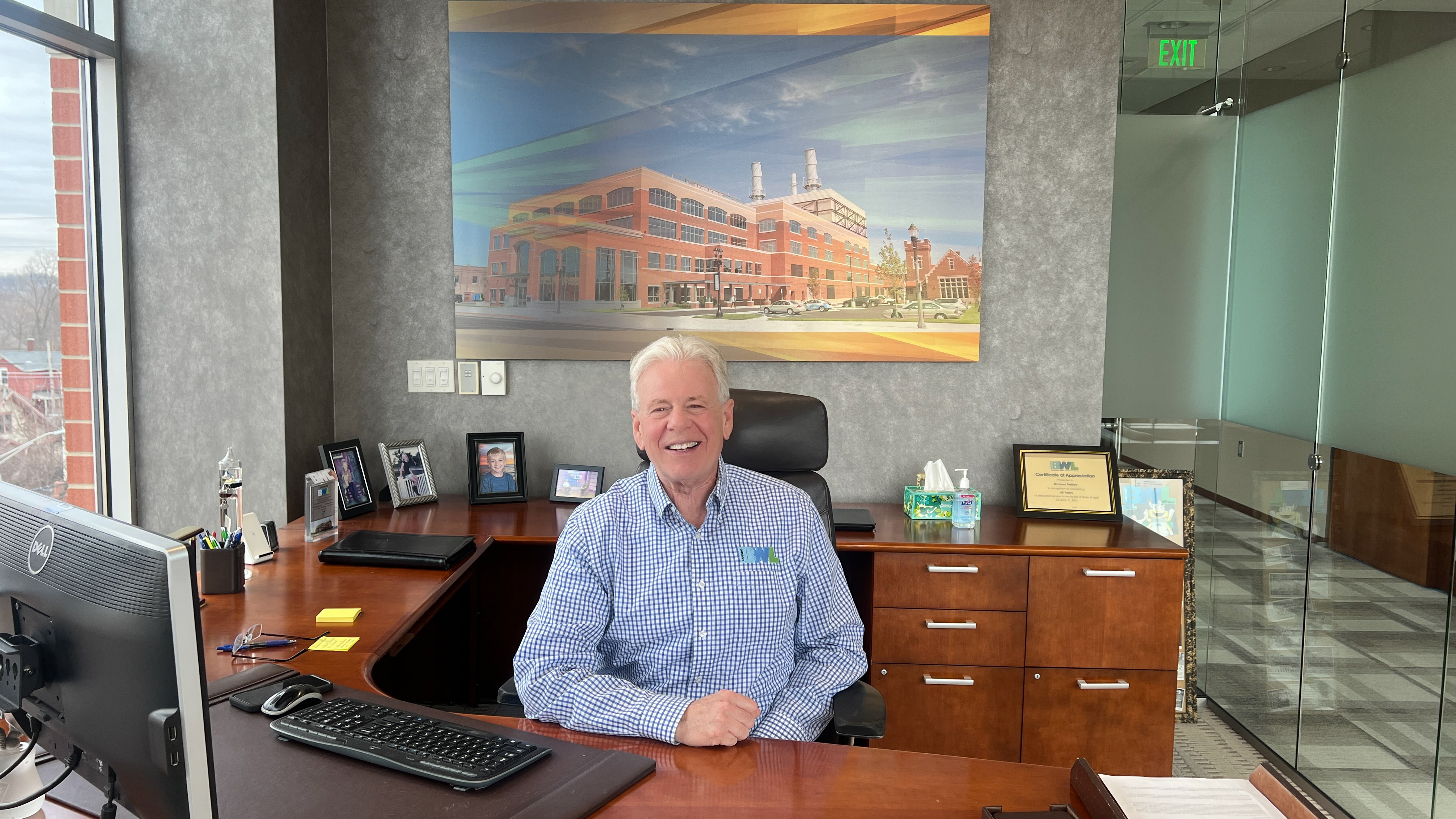 Dick Peffley sitting at his desk smiling.