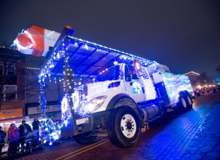 A utility truck is decorated for the Silver Bells in the City parade.