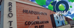 brick building with balloons in the sky