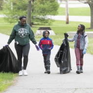 Volunteers help to clean up waste in a river