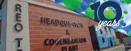 brick building with balloons in the sky